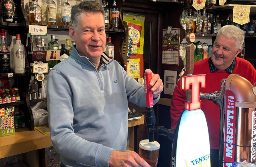 Murdo pictured pouring a pint at the Airlie Street Bar in Alyth