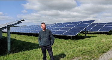 Murdo Fraser MSP stands infront of a solar farm