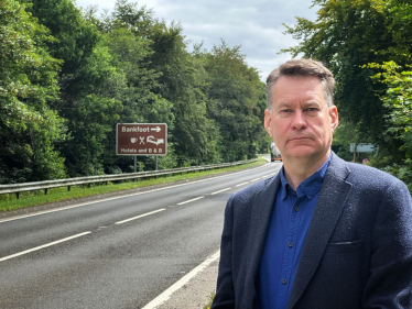 Murdo Fraser MSP beside the A9 Perth to Inverness road