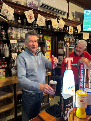 Murdo pictured pouring a pint at the Airlie Street Bar in Alyth